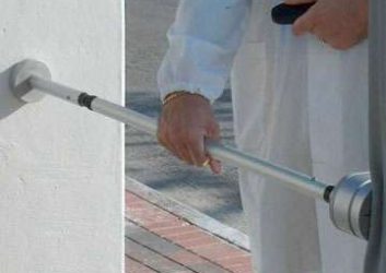 Technician measures the forces exerted as a sliding gate closes to ensure it reverses its action if the gate encounters an obstruction {{brizy_dc_image_alt imageSrc=